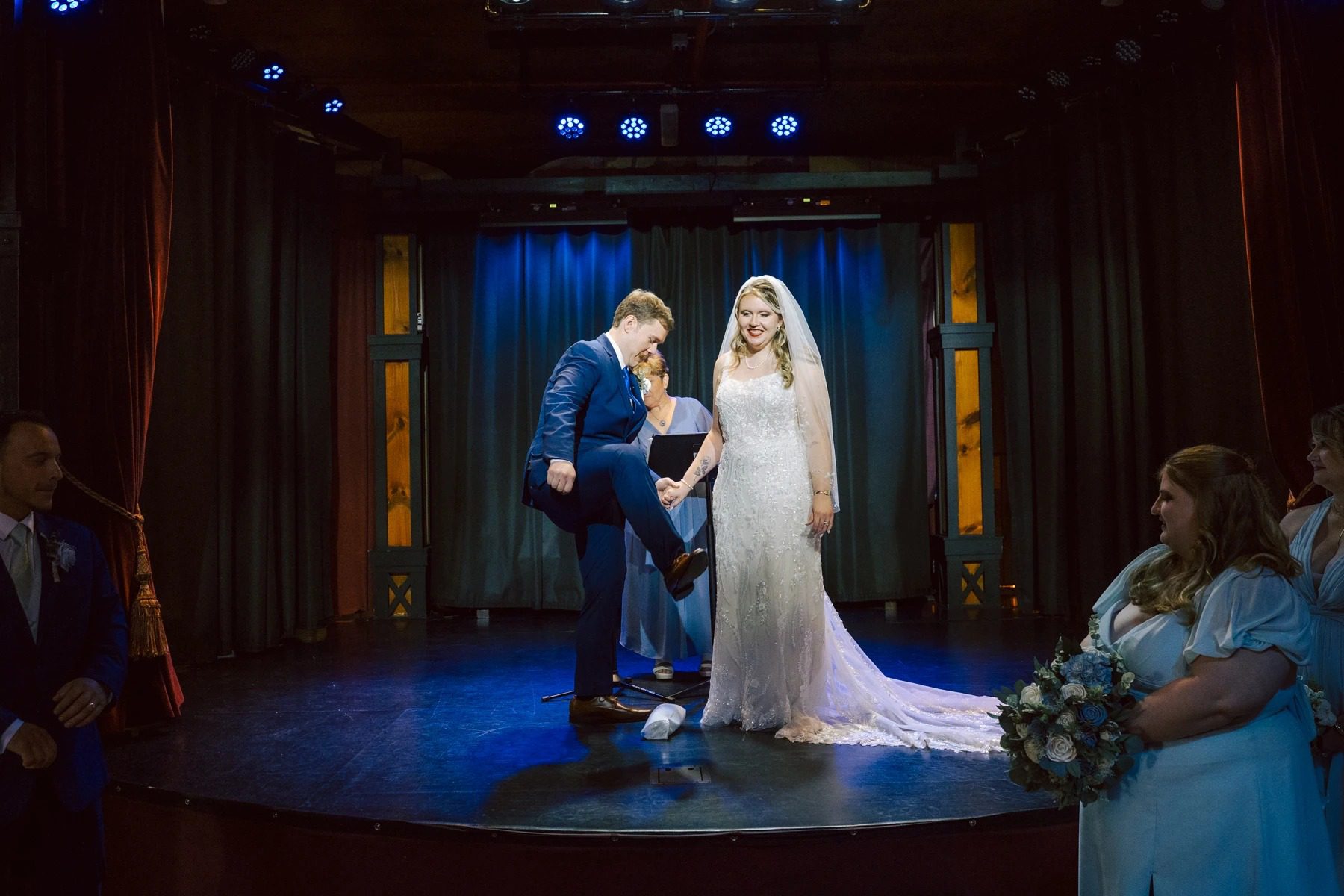 Bride and groom exchanging vows during their wedding ceremony on stage. — Wedding at Dramatic Hall, peekskil, ny