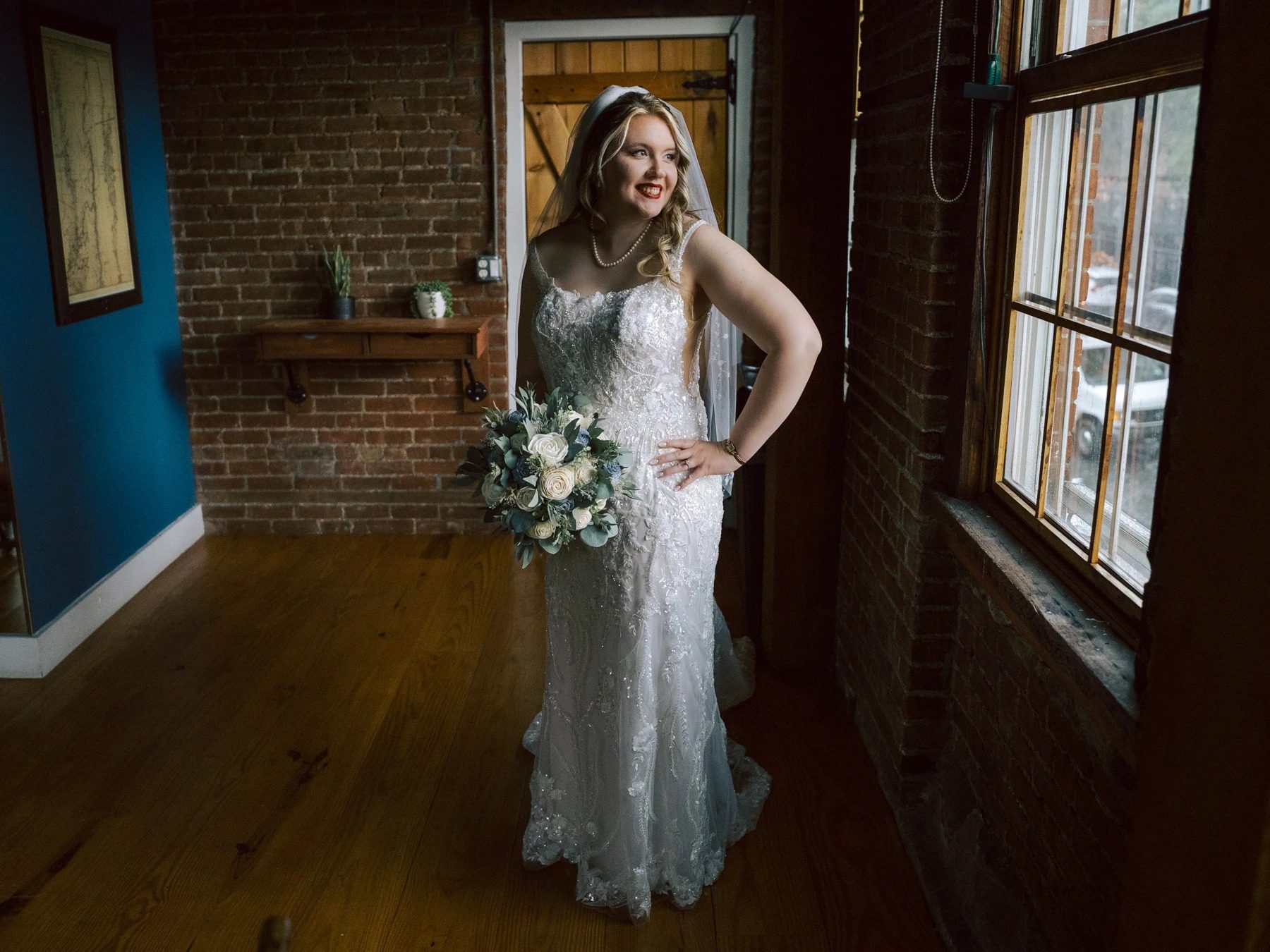 Bride standing alone in an industrial loft, holding her bouquet and posing for a formal portrait. — Wedding at Dramatic Hall, peekskil, ny