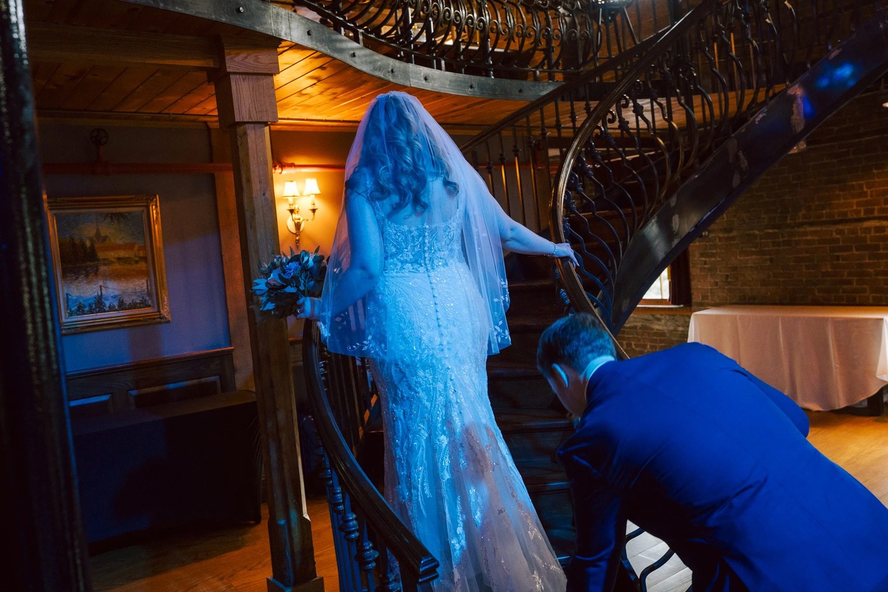 Person in blue clothing examining or touching a large blue shark sculpture in an indoor museum or gallery space. — Wedding at Dramatic Hall, peekskil, ny